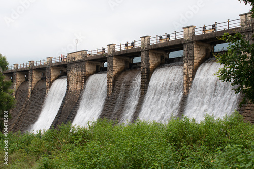 Fotografie water releases from flood gate of topchachi dam with abundant green surrounding,