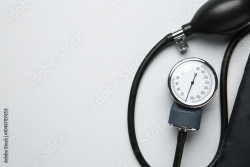 Blood pressure measuring device on light grey background, top view. Space for text