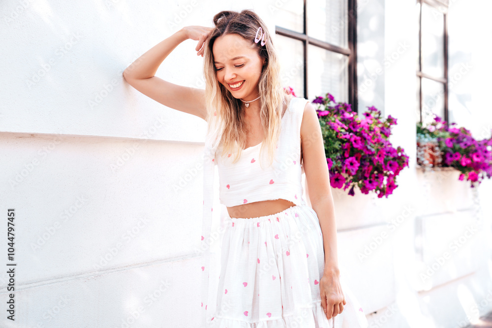 Young beautiful smiling blond woman in trendy summer top and skirt clothes. Sexy carefree woman posing in street at sunset. Positive model outdoors it sunny day. Cheerful and happy Young beautiful smiling blond woman in trendy summer top and skirt clothes. Sexy carefree woman posing in street at sunset. Positive model outdoors it sunny day. Cheerful and happy