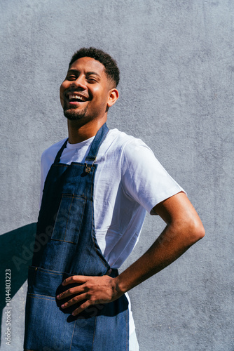 Bakery, happy portrait of hispanic black man in cafe ready for serving pastry, coffee and baked foods. Restaurant, coffee shop and confident waiter barista by counter for service, help and welcome