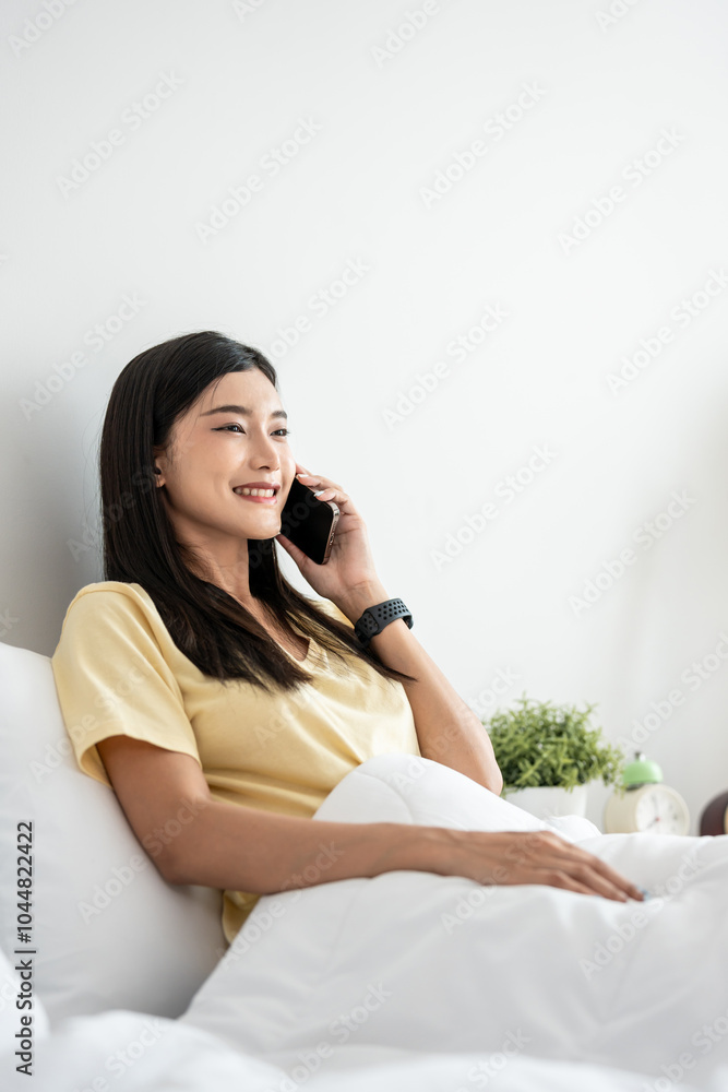 Asian attractive woman use mobile phone call on bed at home in morning. Asian attractive woman use mobile phone call on bed at home in morning.