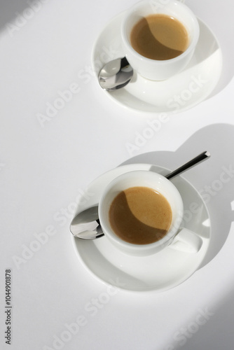 Two Cups of Freshly Made Espresso with Crema on White Table Background. Cafe Still Life.