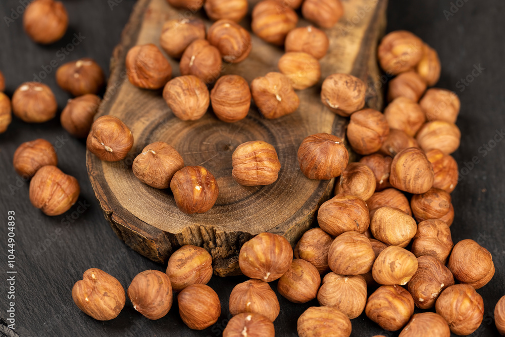 peeled raw hazelnuts on a table and a board peeled raw hazelnuts on a table and a board