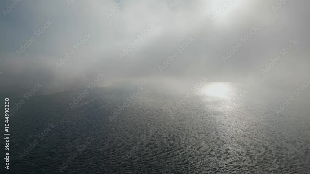 A foggy day over calm water, minimal visibility. Serene and atmospheric seascape. Great for weather, mood, nature, and landscape visuals A foggy day over calm water, minimal visibility. Serene and atmospheric seascape. Great for weather, mood, nature, and landscape visuals