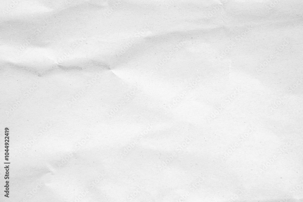 Obraz premium Crumpled white paper texture with a soft, wintery feel, perfect for backgrounds and design.