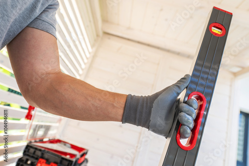 Wallpaper Mural A Worker Using a Leveling Tool in a Well-Lit Indoor Space to Ensure Precise Alignment Torontodigital.ca