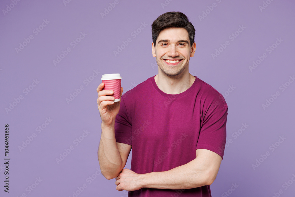 Young smiling happy Caucasian man he wear violet t-shirt casual clothes hold takeaway delivery craft paper brown cup coffee to go isolated on plain pastel light purple background. Lifestyle concept. Young smiling happy Caucasian man he wear violet t-shirt casual clothes hold takeaway delivery craft paper brown cup coffee to go isolated on plain pastel light purple background. Lifestyle concept.
