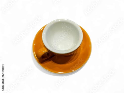 Close-up of a bright orange cup on a white background, with a simple, empty design. Perfect for themes related to kitchen essentials, minimalism, or colorful home decor