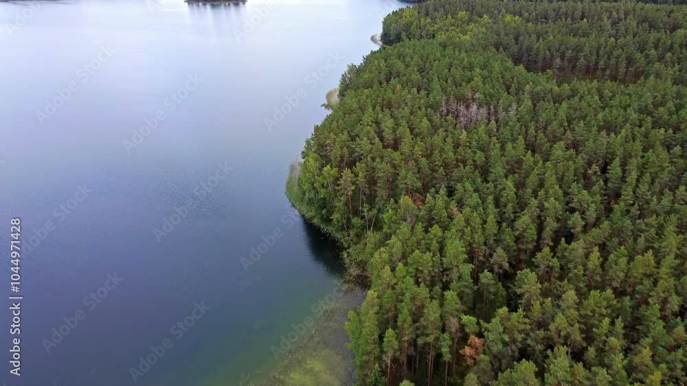 Aerial view of Certoks Velnezers lake in Latvia, surrounded by dense forest. Aerial view of Certoks Velnezers lake in Latvia, surrounded by dense forest.