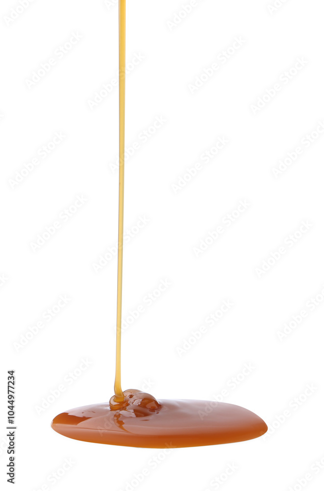 Tasty caramel sauce dripping on white background, closeup Tasty caramel sauce dripping on white background, closeup