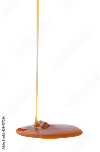 Tasty caramel sauce dripping on white background, closeup