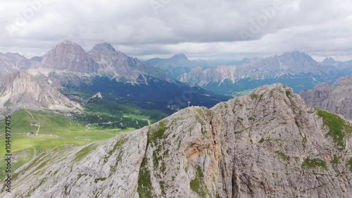 Majestic view of Monte Cernera overlooking lush valleys and distant rocky peaks. photo