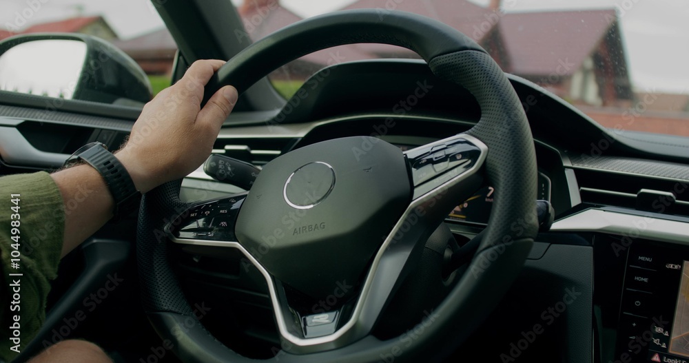 A man drives a car. Close-up of his hands on the steering wheel, an unrecognizable person. View from the car interior. Summer day A man drives a car. Close-up of his hands on the steering wheel, an unrecognizable person. View from the car interior. Summer day