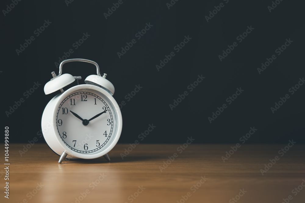 Time managment and Work management concept.Clock isolate on the wooden table and black background. Time managment and Work management concept.Clock isolate on the wooden table and black background.