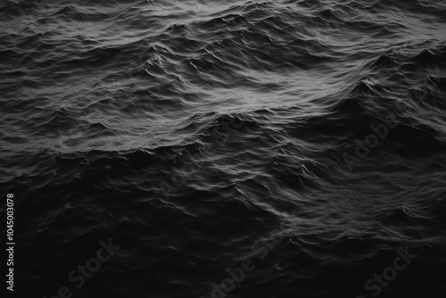 Dark and moody, the ocean waves roll in a deep, dramatic fashion. photo