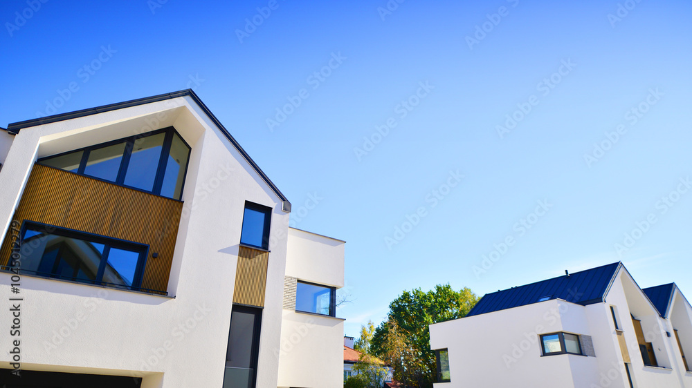 Harmony with nature, eco architecture. Terraced single family homes in newly developed housing estate. The real estate market in the suburbs with lush greenery surrounding. Harmony with nature, eco architecture. Terraced single family homes in newly developed housing estate. The real estate market in the suburbs with lush greenery surrounding.