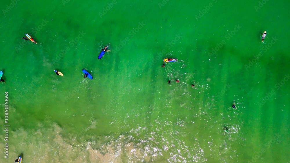 Aerial view of Surfers finding waves in Lombok, Indonesia