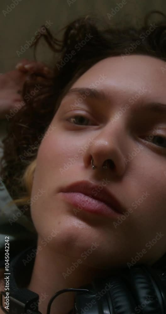 Upset young woman looks at the camera lying on the bed, top view Upset young woman looks at the camera lying on the bed, top view