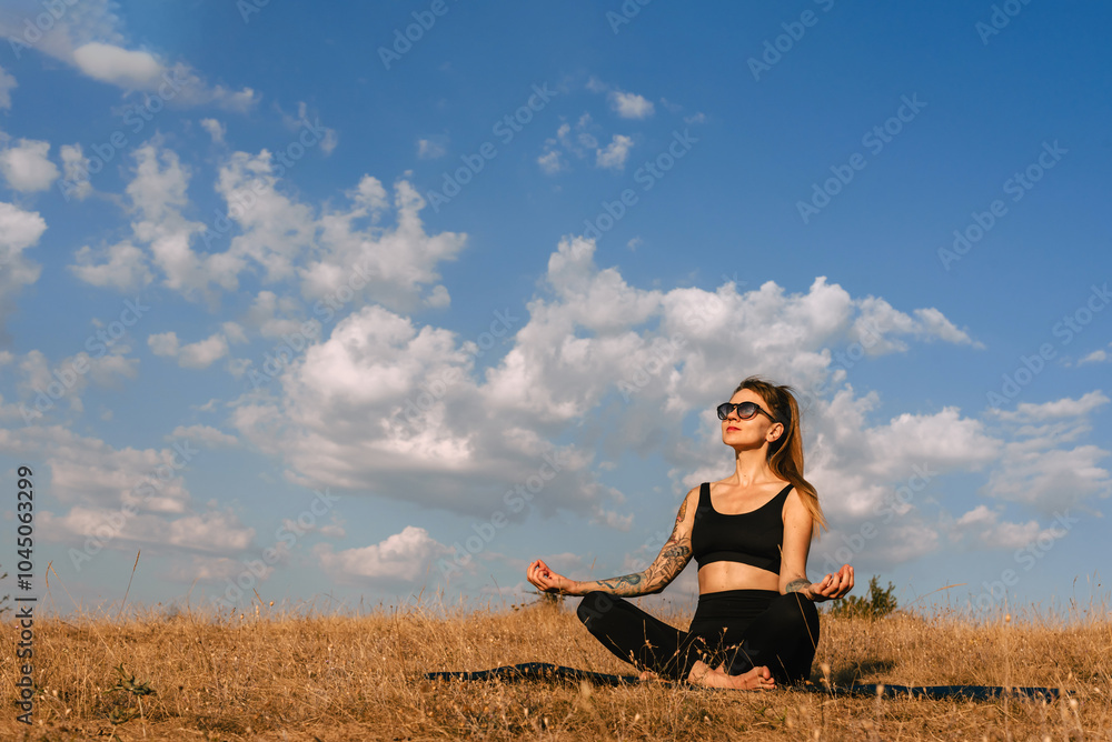 Woman Practicing Yoga Outdoors Early in Morning