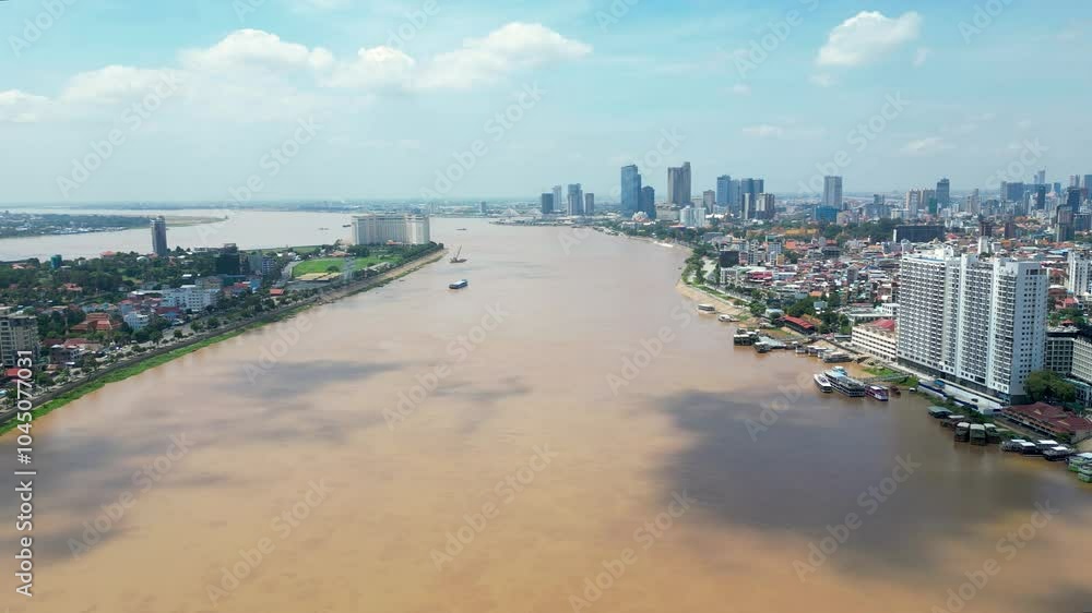 Tonle sap river flowing through phnom penh with city skyline and boats on the water, aerial view Tonle sap river flowing through phnom penh with city skyline and boats on the water, aerial view