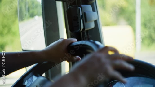 Truck Driver Steering the Wheel: Close-Up of Hands Controlling the Vehicle for Long-Haul Cargo Transport and Road Navigation. High quality 4k footage