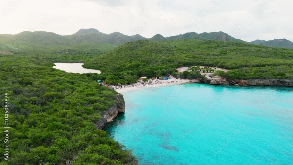 Drone panoramic overview of the coastline at Kenepa Grande , Curacao, with clear turquoise waters, lush green surroundings, and sandy beach shoreline Drone panoramic overview of the coastline at Kenepa Grande , Curacao, with clear turquoise waters, lush green surroundings, and sandy beach shoreline