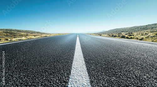 Wallpaper Mural The Open Road: A straight, black asphalt road stretches endlessly under a clear blue sky, beckoning the viewer to embark on a journey of endless possibilities. Torontodigital.ca