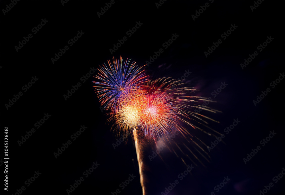 Three fireworks explode in the night sky against a black, isolated background. Three fireworks explode in the night sky against a black, isolated background.