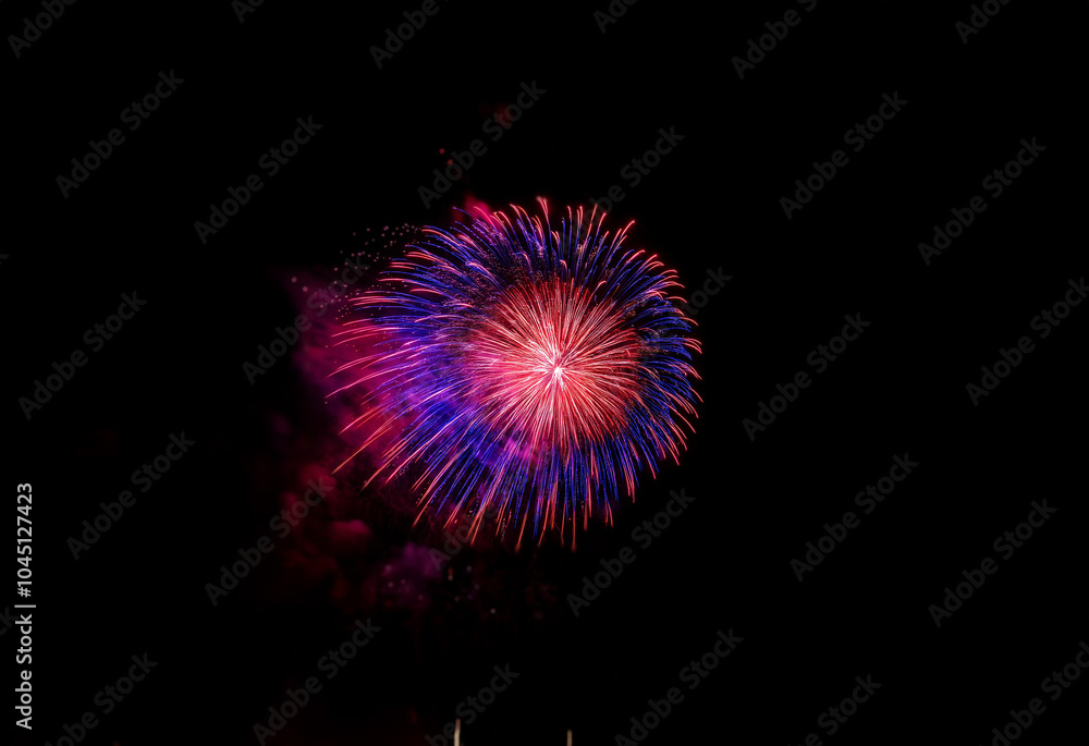 A single firework explodes in a burst of red and blue against a dark, isolated background. A single firework explodes in a burst of red and blue against a dark, isolated background.