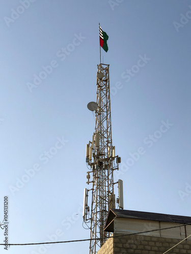 The telecommunication tower in a dramatic blue sky filled with clouds the city of Karachi Pakistan. photo