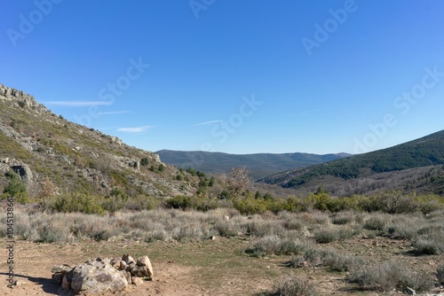 A vast, rolling landscape with rolling hills and a clear blue sky.