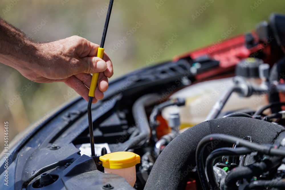 Young overwhelmed man seeing broken car engine. On your vacation to the beach, your rental vehicle broke down. Young overwhelmed man seeing broken car engine. On your vacation to the beach, your rental vehicle broke down.