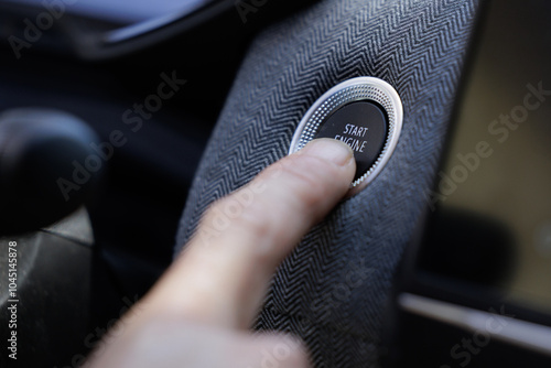 Tableau sur toile Close-up of a man's hand starting the car engine with the Start Stop button
