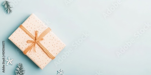 Decorative gift box with ribbon on pastel background