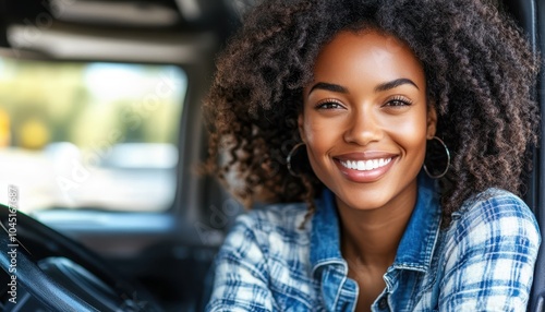 Female truck driver smiling while taking a break in her vehicle