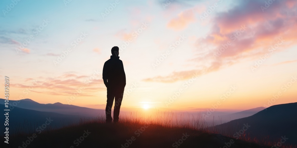 Silhouette of a person on a hilltop at sunset Silhouette of a person on a hilltop at sunset