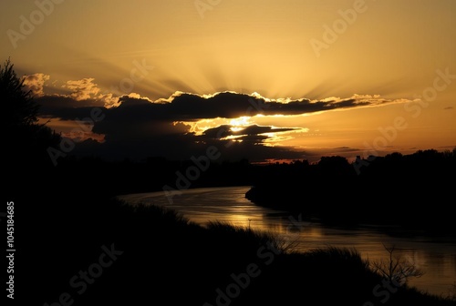 Silhouetted Serenity Backlighting the river creates a dramatic s photo