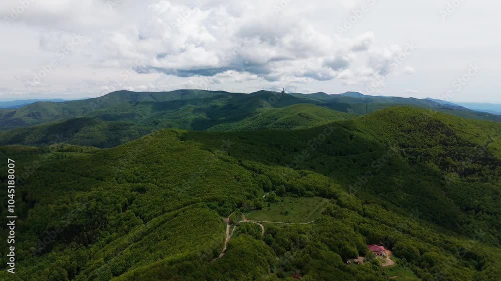 Buzludja Monument captured in slow zoom landscape shot with green mountains. Buzludja Monument captured in slow zoom landscape shot with green mountains.