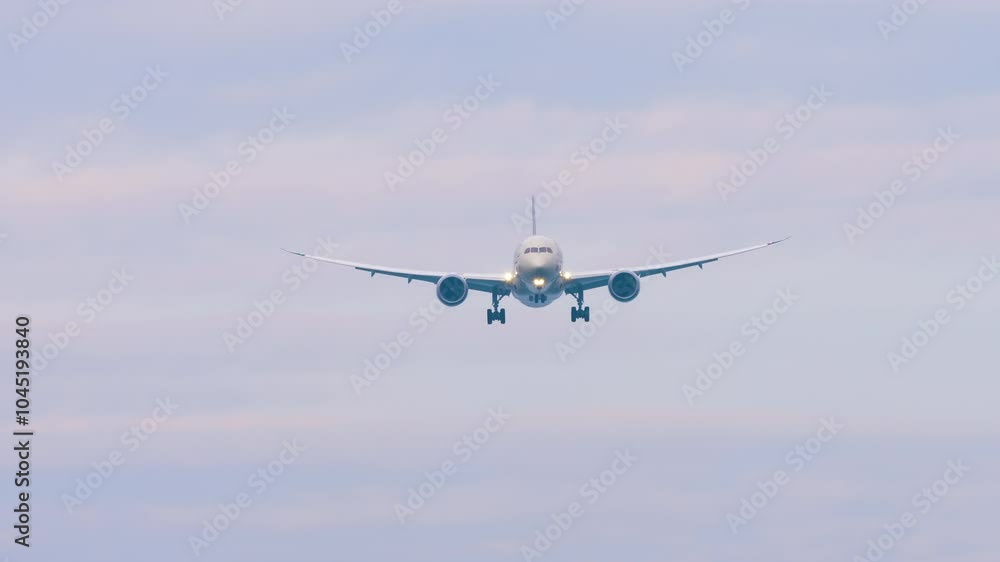 Passenger plane with unrecognizable livery approaching landing. Plane in the sky, front view Passenger plane with unrecognizable livery approaching landing. Plane in the sky, front view