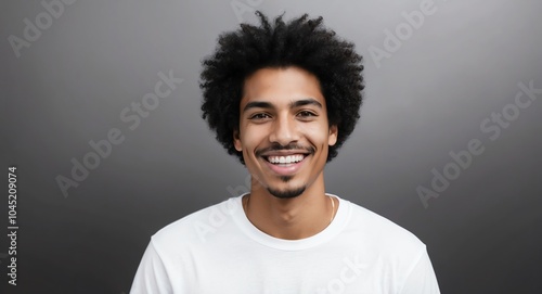 mixed race young man black background wearing plain white tshirt smiling happy portrait