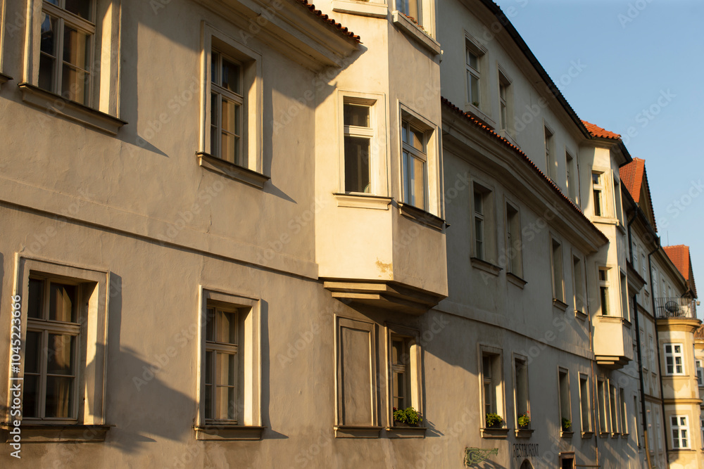 Fototapeta premium A large building that features an abundance of windows along with a bright red roof that adds to its charm and character