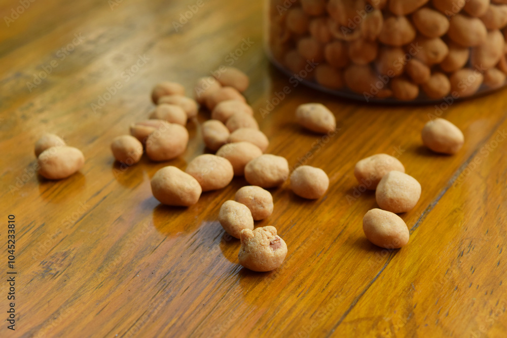 Closeup photo of some dried atomic Nuts and food storage or jar on wooden table Closeup photo of some dried atomic Nuts and food storage or jar on wooden table