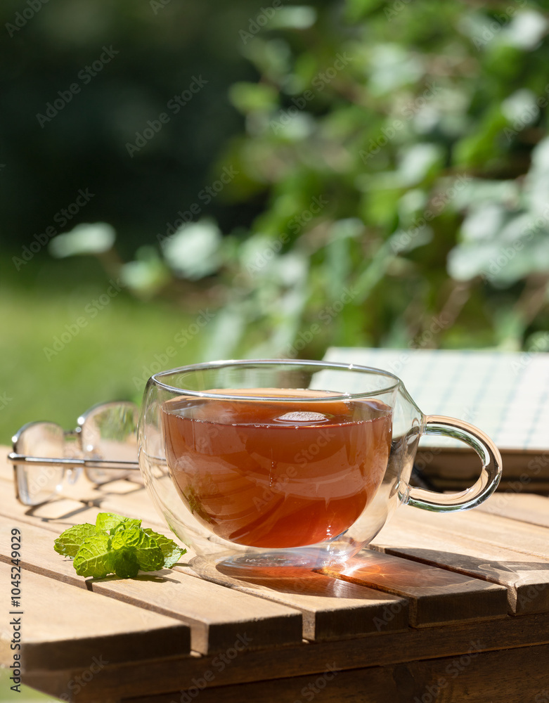 Cup of tea and mint on wooden table Cup of tea and mint on wooden table
