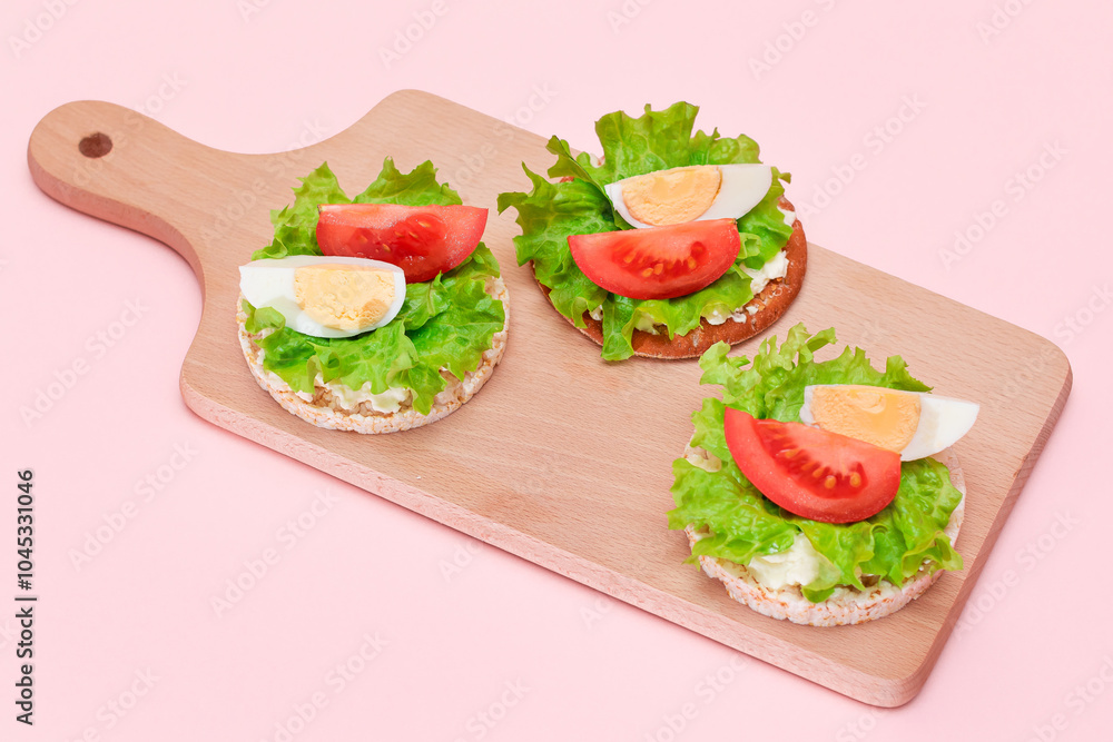 Rice Cake Sandwiches with Tomato, Lettuce and Egg on Wooden Cutting Board. Easy Breakfast. Diet Food. Quick and Healthy Sandwiches. Crispbread with Tasty Filling. Healthy Dietary Snack Rice Cake Sandwiches with Tomato, Lettuce and Egg on Wooden Cutting Board. Easy Breakfast. Diet Food. Quick and Healthy Sandwiches. Crispbread with Tasty Filling. Healthy Dietary Snack