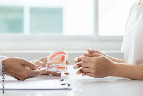 woman consults dentist about her toothache for treatment in dental clinic and dentist gives advice on right symptoms and treatment method for patient. concept consulting dentist about dental treatment