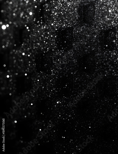 Black glitter adds an abstract, textured background to a design element.