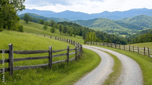 Scenic winding road through green hills and mountains under a cloudy sky.