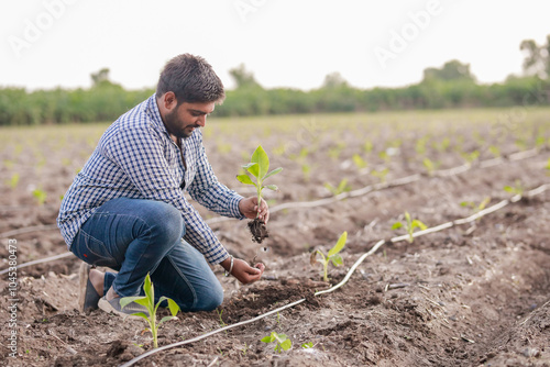 happy Indian farmer holding Banana tree