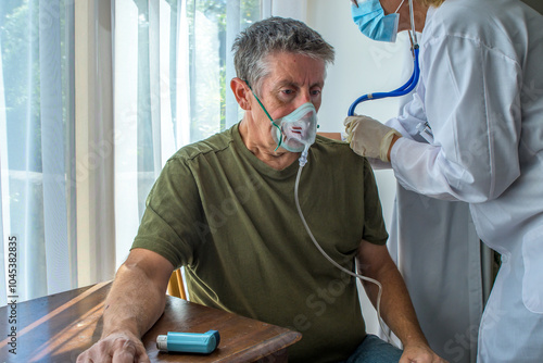 Oxygen face mask is placed on a man with breathing difficulty due to his lung disease. Covid-19, COPD, asthma and pneumonia require oxygen therapy