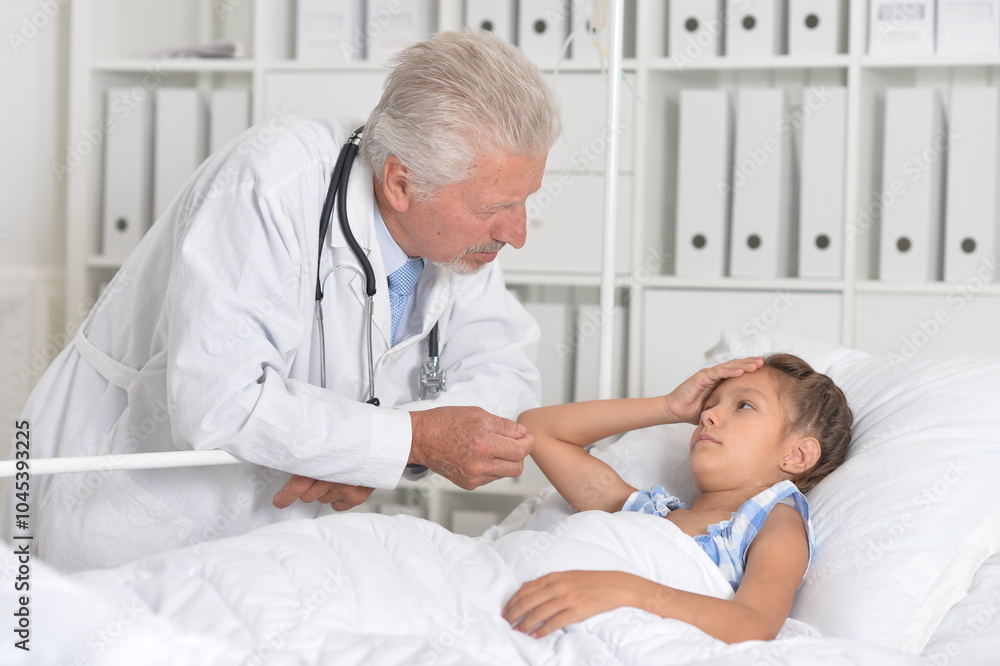 The little girl is in the hospital with a doctor